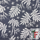 Close-up view of Coastal Canopy fabric featuring an intricate botanical pattern of white tropical palm leaves, monstera leaves, and hibiscus flowers over a dark slate grey background.