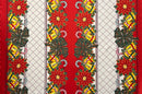 Holiday-themed polyester fabric featuring vertical panels of vibrant red poinsettias with green leaves, golden Christmas bells with red bows, and candy canes, separated by white sections with a grey diamond lattice pattern and red borders.