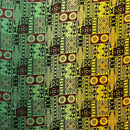 A flat-lay view of a Fijian Tapa Barkcloth Fabric (Style 3) featuring a traditional geometric pattern. The design consists of repeating rectangular tiles in a vibrant gradient of green, maroon, and yellow, filled with intricate black tribal motifs including sunbursts, triangles, and linear hatches.