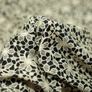 Ivory Flower Lace Pattern on Black Printed Spandex Fabric | Blue Moon Fabrics