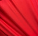 Solid black red challis fabric draped in soft, spiral folds.