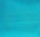 Solid aqua rayon challis fabric draped in soft, spiral folds. 