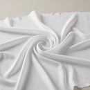 Solid white rayon challis fabric draped in soft, spiral folds.